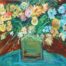 Vicente Ydrach's version of a still life of flowers on a base on top of a round bluish table.
